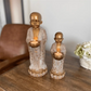 decorative buddhist monk candle holder with candlelight on a console tables