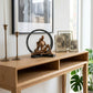 black and copper circular decorative sculpture styled on a modern console table