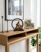 black and copper circular decorative sculpture styled on a modern console table