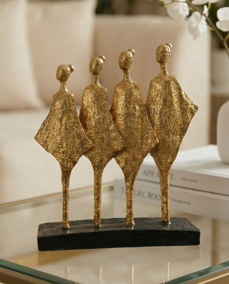 handmade black and gold abstract sculpture with four figures symbolising unity and balance