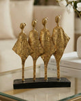 handmade black and gold abstract sculpture with four figures symbolising unity and balance