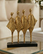 handmade black and gold abstract sculpture with four figures symbolising unity and balance