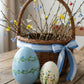 blue ceramic easter egg decorations styled on a spring table