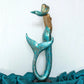 decorative mermaid sculpture styled on a console table