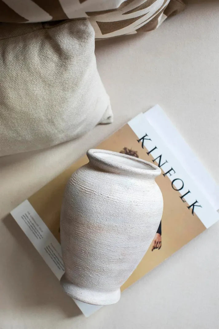 textured cream and brown ceramic vase styled on a modern console table
