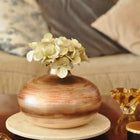 decorative flat ceramic vase styled on a console table in a modern interior