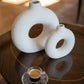 decorative cream ring ceramic vase styled on a modern console table