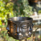 modern sculptural face planter in metallic black for interior decor