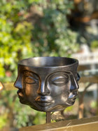 modern sculptural face planter in metallic black for interior decor