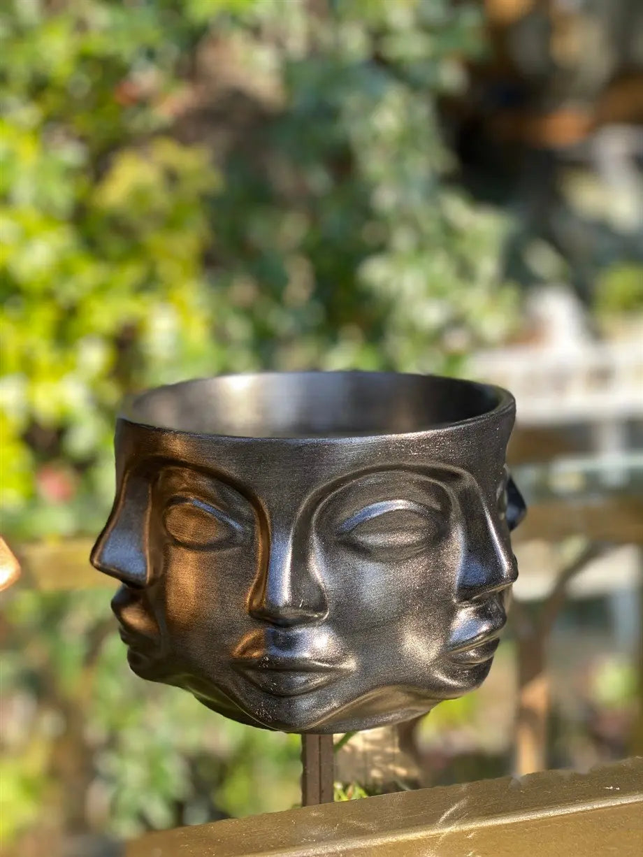 modern sculptural face planter in metallic black for interior decor