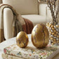 gold ceramic easter egg decorations styled on a spring table