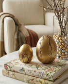 gold ceramic easter egg decorations styled on a spring table