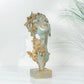 decorative butterfly mask sculpture styled on a modern console table