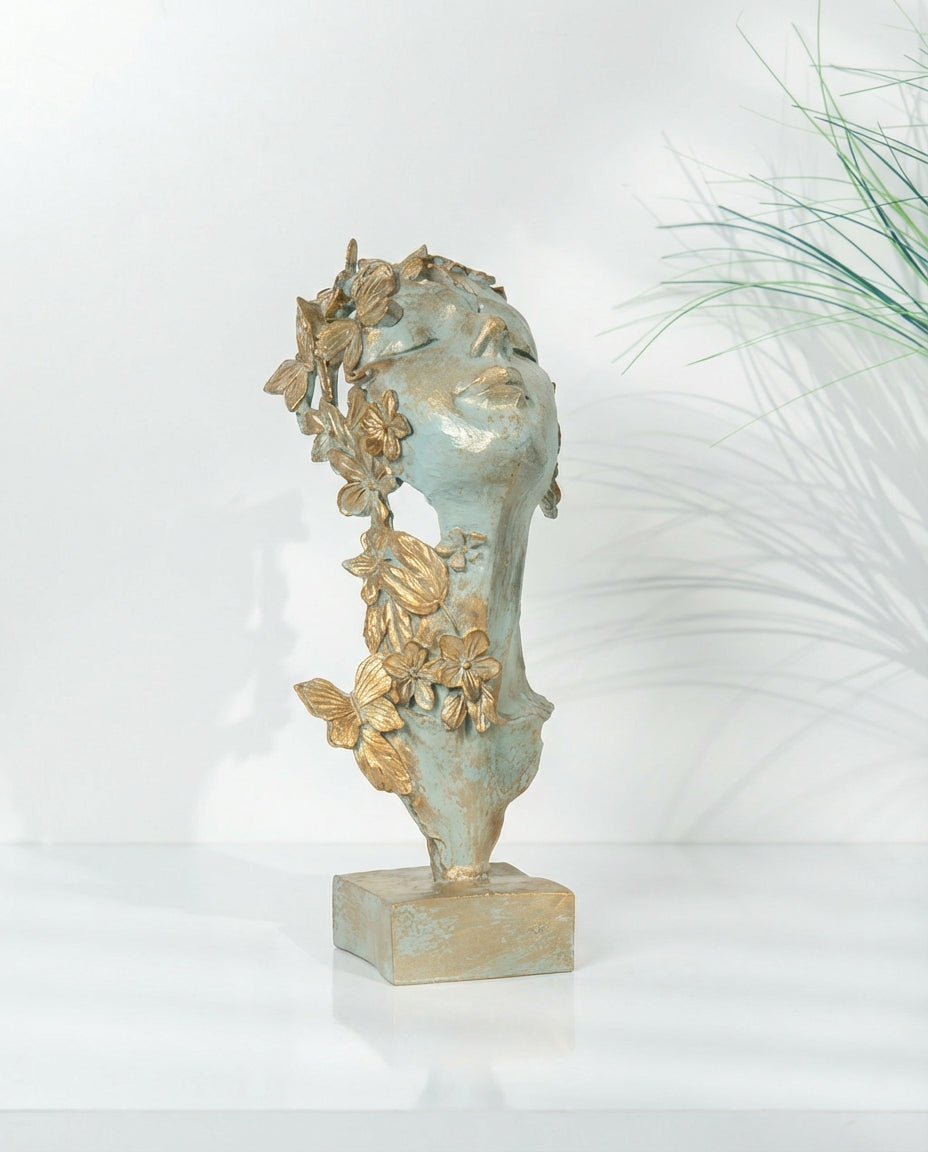 decorative butterfly mask sculpture styled on a modern console table