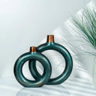 decorative green ceramic ring vase set styled on a console table