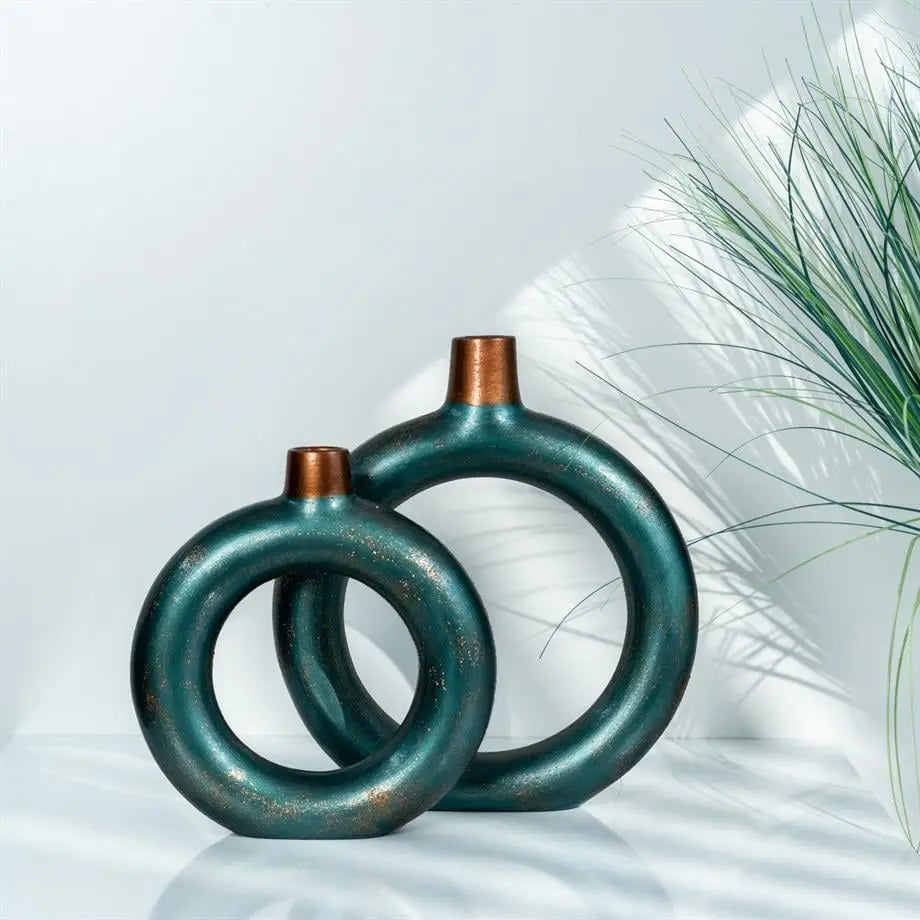 decorative green ceramic ring vase set styled on a console table