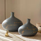 decorative grey and gold ceramic vases styled on a modern console table