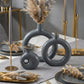 sculptural grey and gold ring ceramic vases styled on a modern console table