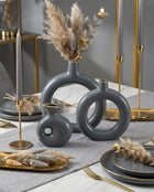 sculptural grey and gold ring ceramic vases styled on a modern console table