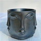 decorative metallic black mini planter with succulent plant on desk