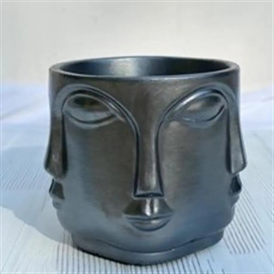 decorative metallic black mini planter with succulent plant on desk