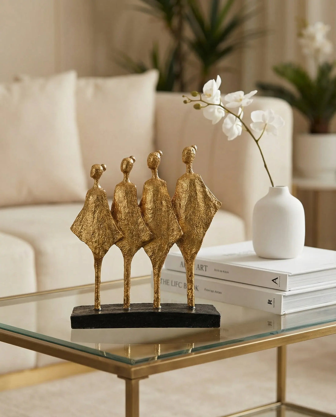 modern black and gold abstract sculpture decor styled on a console table