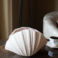 modern oyster shell ceramic vase styled with dried branches on a shelf
