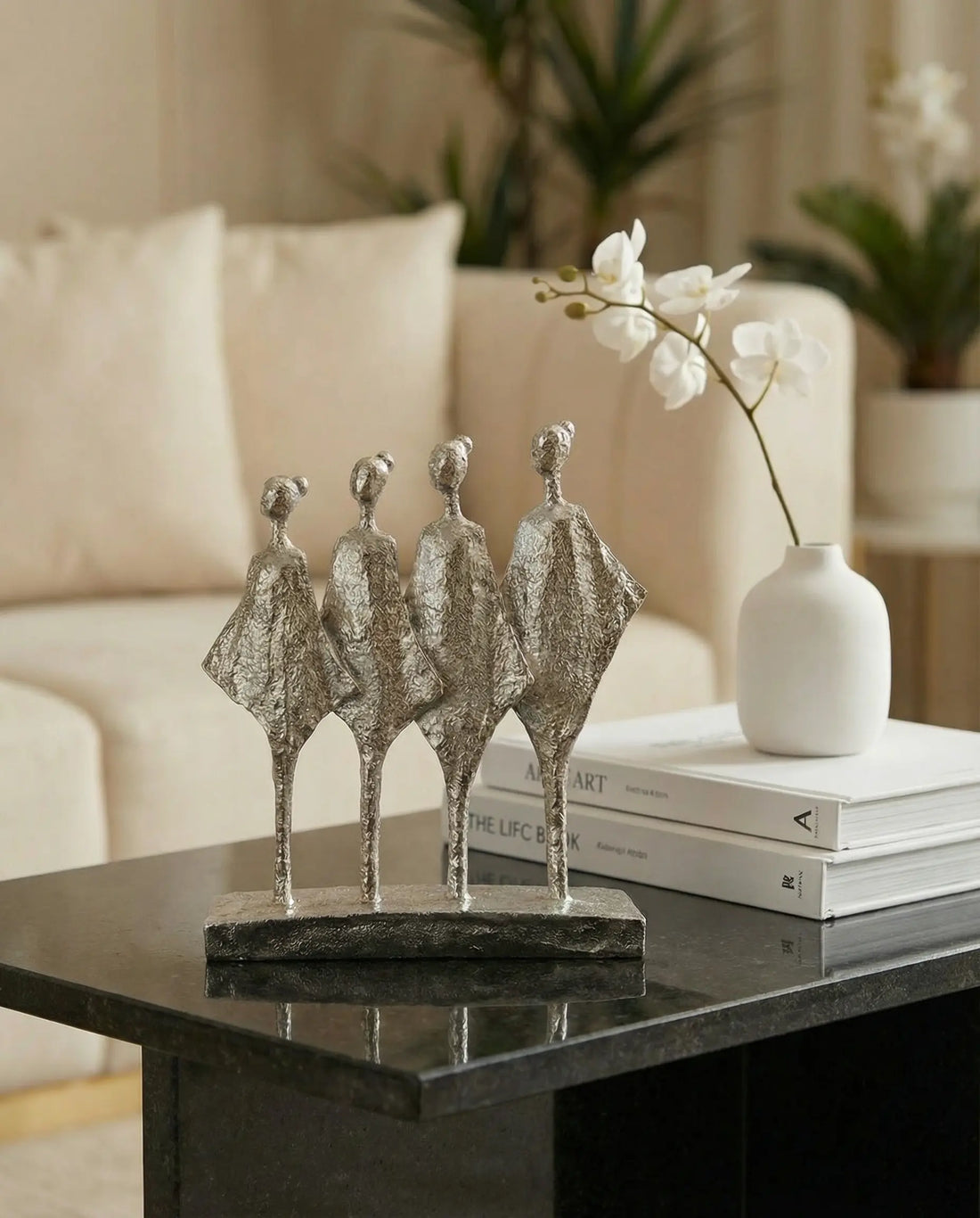 modern silver abstract sculpture decor styled on a console table
