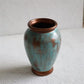 sculptural turquoise ceramic vase with copper details for contemporary interiors