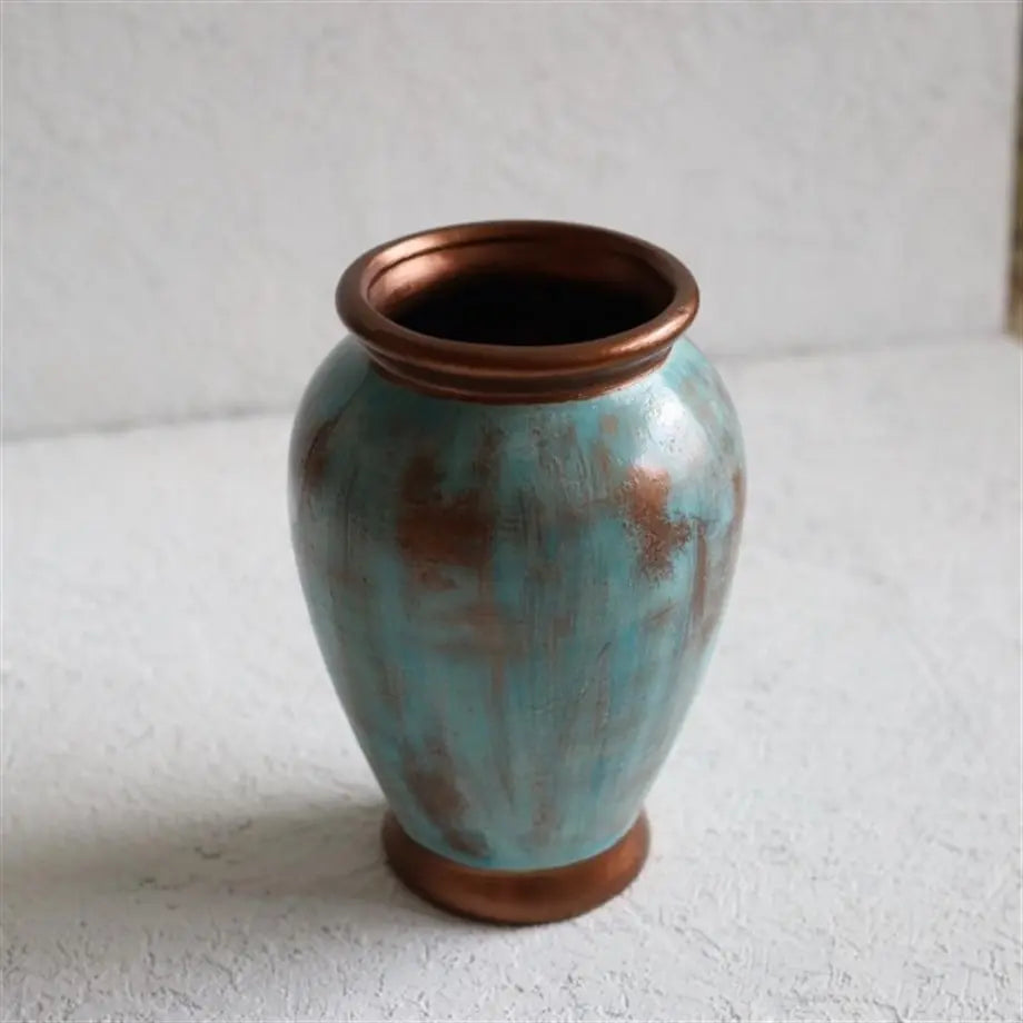 sculptural turquoise ceramic vase with copper details for contemporary interiors