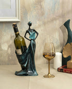decorative sculptural wine holder in petrol green styled on a dining table