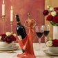 decorative sculptural wine holder in pomegranate red styled on a dining table