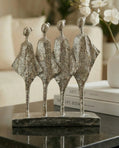handmade silver abstract sculpture with four figures symbolising unity and balance