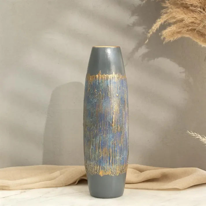 tall cylindrical ceramic vase styled on a modern console table