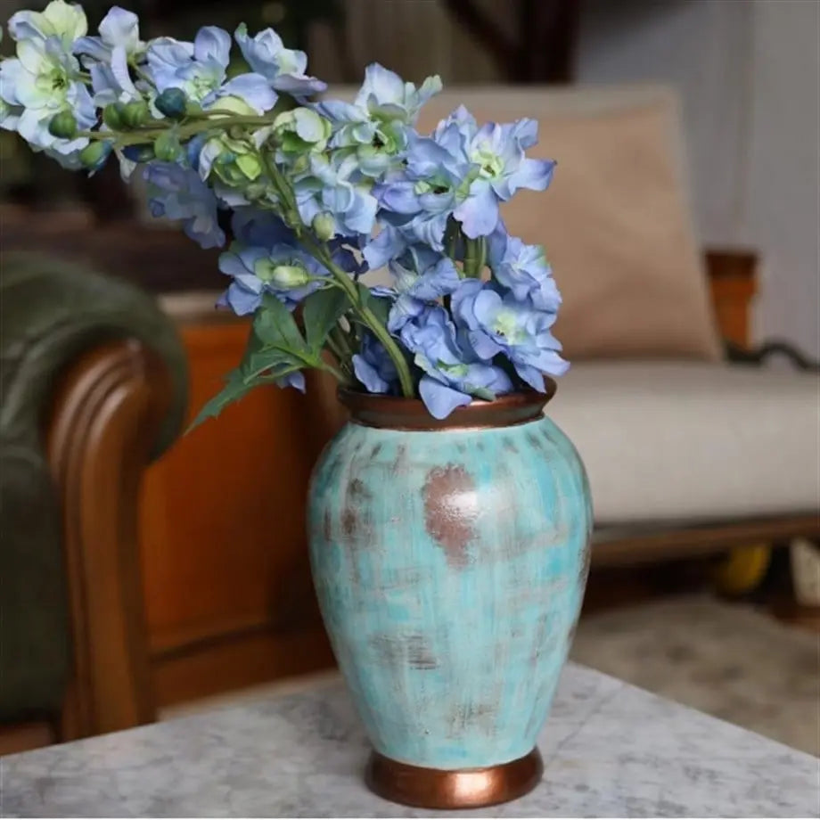 decorative turquoise ceramic vase styled on a modern console table