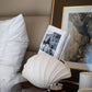 sculptural oyster shell ceramic vase styled on a console table